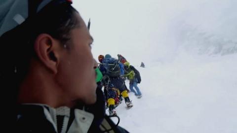 Climbers watching the avalanche approach