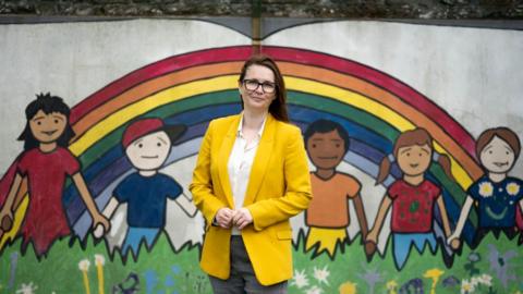 Wales' Education Minister Kirsty Williams poses for a photograph in front of a rainbow mural at Roath Park Primary School on June 29, 2020 in Cardiff