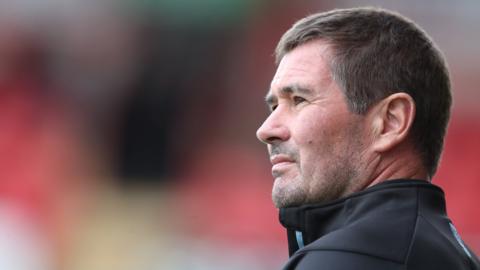 Mansfield boss Nigel Clough watches on from the sidelines