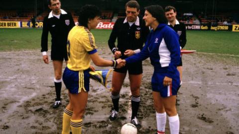 England captain Carol Thomas (right) shakes hands with her Swede counterpart before the start of the second leg of the 1984 Women's Euros final at Luton