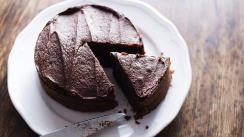 Cutting a chocolate cake into pieces