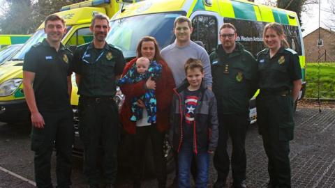 The couple and their children and paramedics