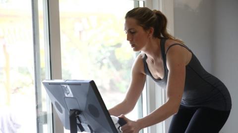 Women uses bike machine