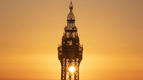 sun shines through Blackpool Tower