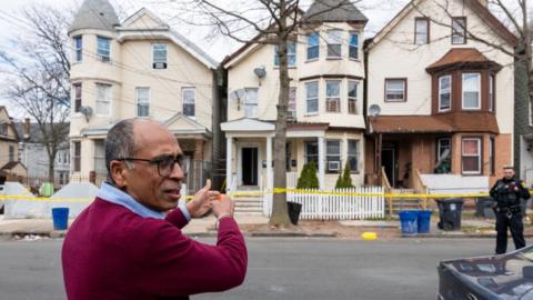 Newark City employee Sushil Nagpal stands outside of homes that were damaged and had to be evacuated