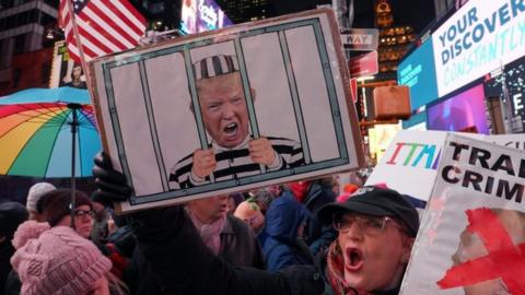 Protesters in favour of President Trump's impeachment gather in New York's Times Square on Tuesday