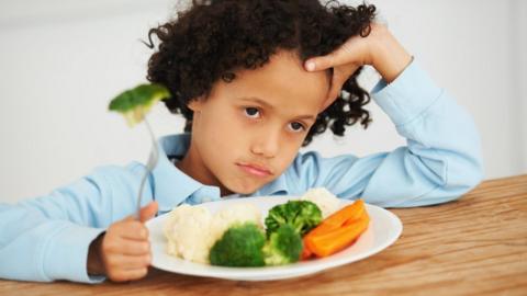 A child eating vegetables