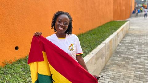 Nana Adusei holding Ghana's flag