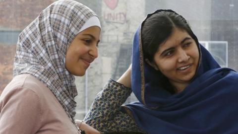 Malala Yousefzai (right) and 17-year-old Syrian refugee Muzoon Almellehan speak at the City Library in Newcastle Upon Tyne (22 December 2015)