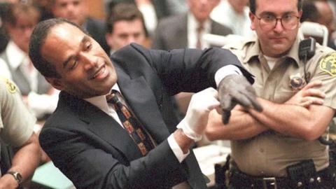 OJ Simpson tries on glove in front of jury at his trial