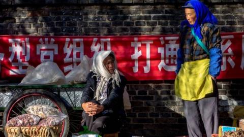 Local women sell produce in the market. Zhongyi market, located at the southern gate of Dayan ancient city, in Lijian, Yunnan Province in China