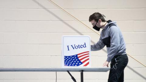 A voter casts his ballot in 2020