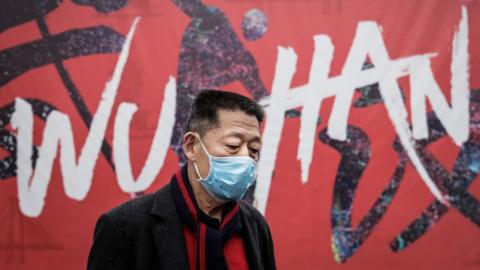 A man wears a mask while walking in the street on January 22, 2020 in Wuhan, Hubei province, China.