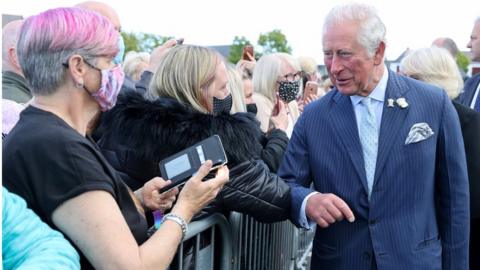 Prince Charles bumps elbows with a well-wisher at Bangor