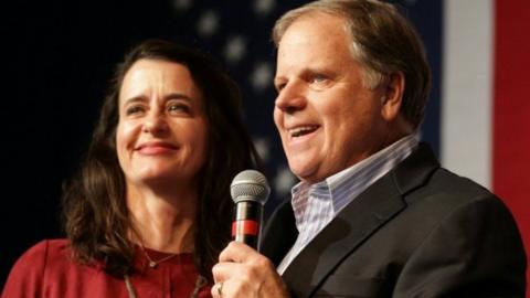 Democratic US Senate candidate Doug Jones speaks to his supporters as his wife stands by his side