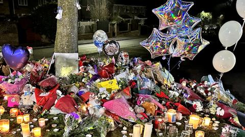 General view of flowers left near the scene of children's lake deaths in Kingshurst