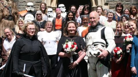 The couple and their guests dressed in Star Wars costumes outside the church