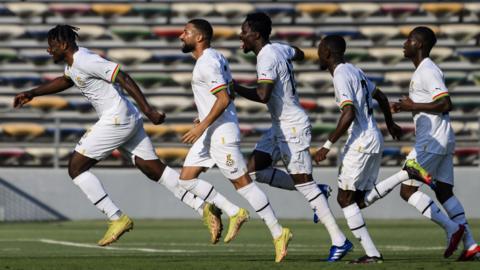 Ghana players celebrate a goal against Switzerland