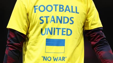 'NO WAR' displayed on a player's shirt.