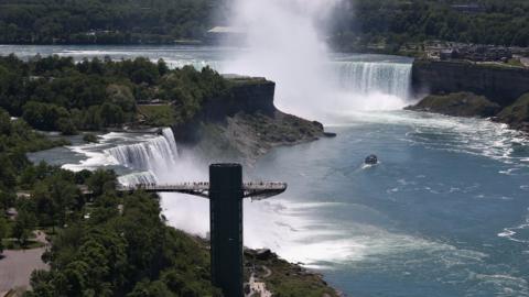 Tourists overlook Niagara Falls from the American side of the site