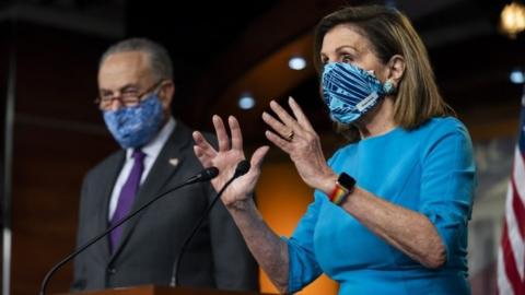 Chuck Schumer and Nancy Pelosi speak at a media conference