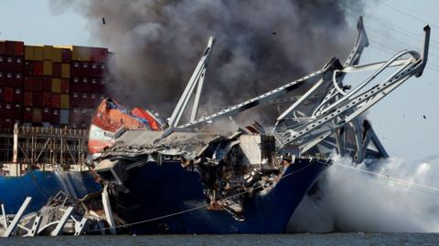 Smoke rises from the cargo ship Dali