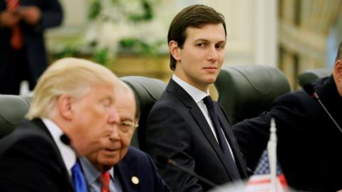 White House senior advisor Jared Kushner (C) sits alongside U.S. President Donald Trump (L) and Commerce Secretary Wilbur Ross (2nd L)