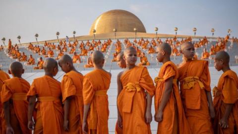 Young monks gather during the yearly ceremony of Makha Bucha at Wat Dhammakaya in the north of Bangkok, Thailand on February 24, 2024.