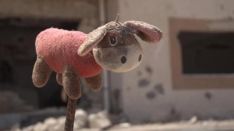 A child's teddy lies abandoned in Sirte