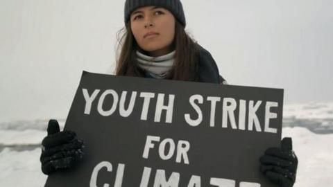 Mya-Rose Craig holds a Youth Strike for Climate sign