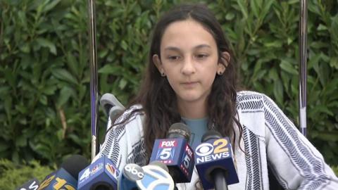 Twelve-year-old Lola Pollina speaks to reporters