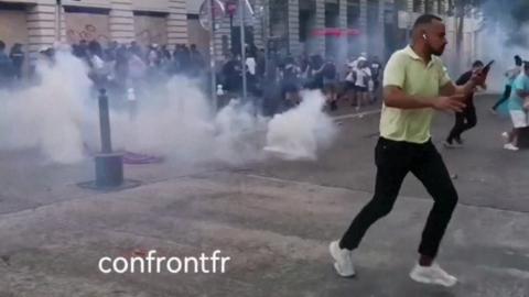 Person running from tear gas