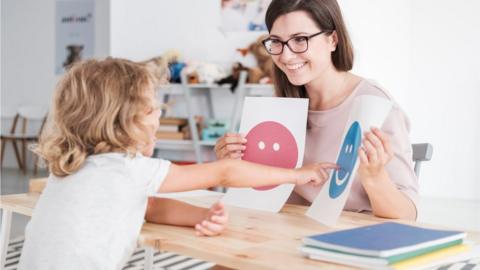 Child with adult in classroom