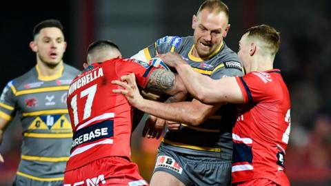 Castleford forward Liam Watts is held by Hull KR pair Elliot Minchella and Frankie Halton