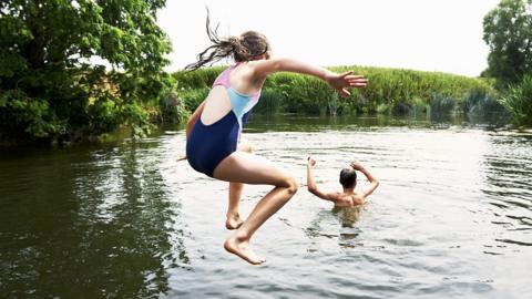 Children swimming in a river