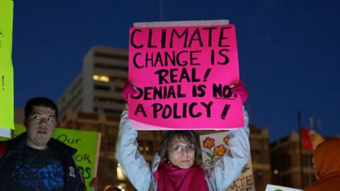 Protesters display signs in support of the environment during a rally against climate change in San Diego, California on February 21, 2017