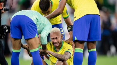 Neymar is consoled by team-mates after Brazil's loss to Croatia