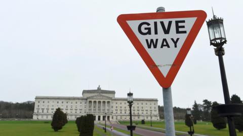 A Give Way traffic sign is seen on the road leading to Stormont, the home of Northern Ireland's Assembly