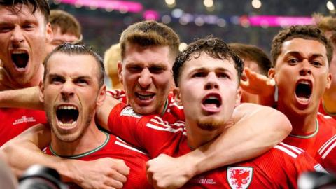 Wales football team celebrate Gareth Bale's goal against USA in their opening game at the 2022 World Cup in Qatar