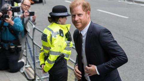 Prince Harry, next to police officer