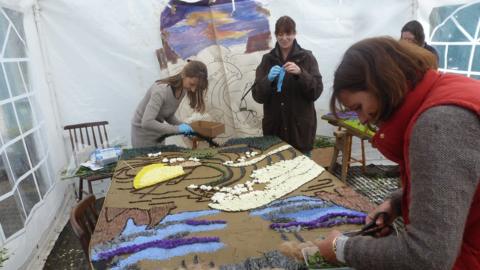 A well dressing being made