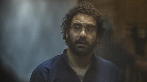 File photo showing Alaa Abdel Fattah in court in March 2015