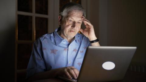 A man gambles at his laptop