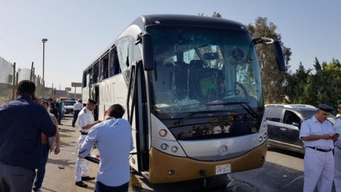 Police near the shattered bus in Giza, Egypt, 19 May