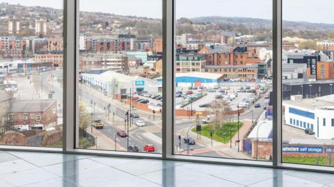 An empty office building overlooking a road.