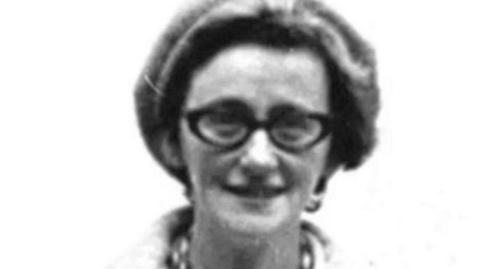 Shows Kathleen Thompson wearing glasses