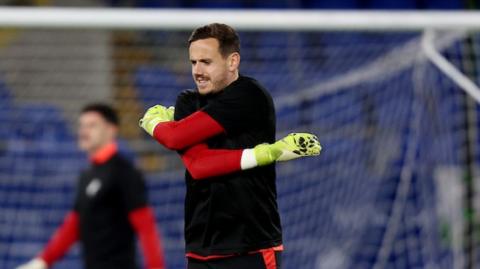 Wales goalkeeper Danny Ward warms up