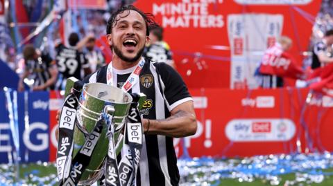 Jodi Jones holds the League Two play-off final trophy at Wembley
