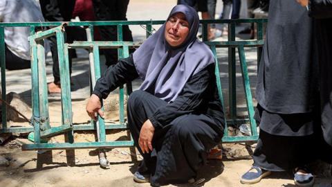 A Palestinian woman reacts during the funeral in Gaza City for several people killed in an Israeli strike on a police post in the Jabalia area (14 July 2026)
