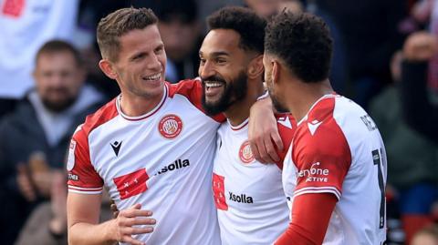 Jordan Roberts is embraced by his team-mates after scoring against Luton 